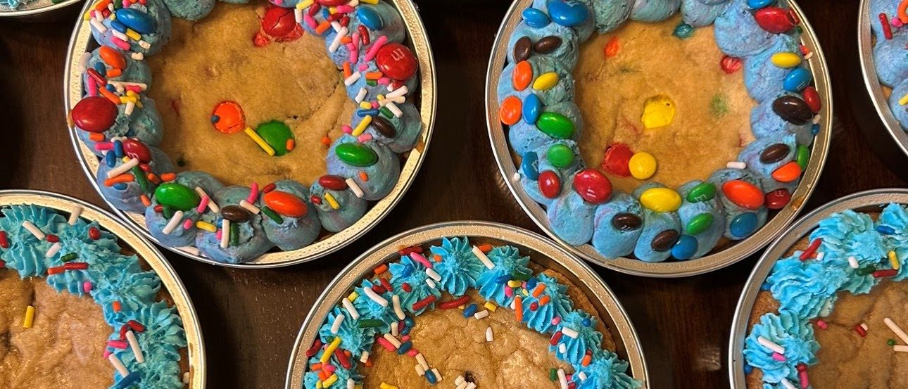 Chocolate chip and M&M cookie cakes with blue frosting borders